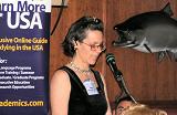 Cheryl Darrup-Boychuck maintains focus at usjournal.com's Advertiser Luncheon, 25 May 2004, as the fish prepares to chomp her forehead...